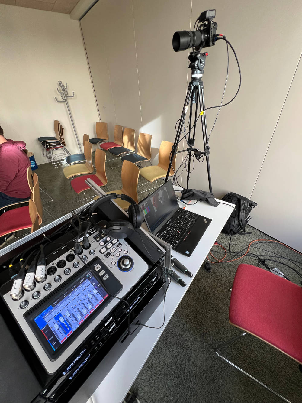 Room setup consisting of camera, laptop and mixing console